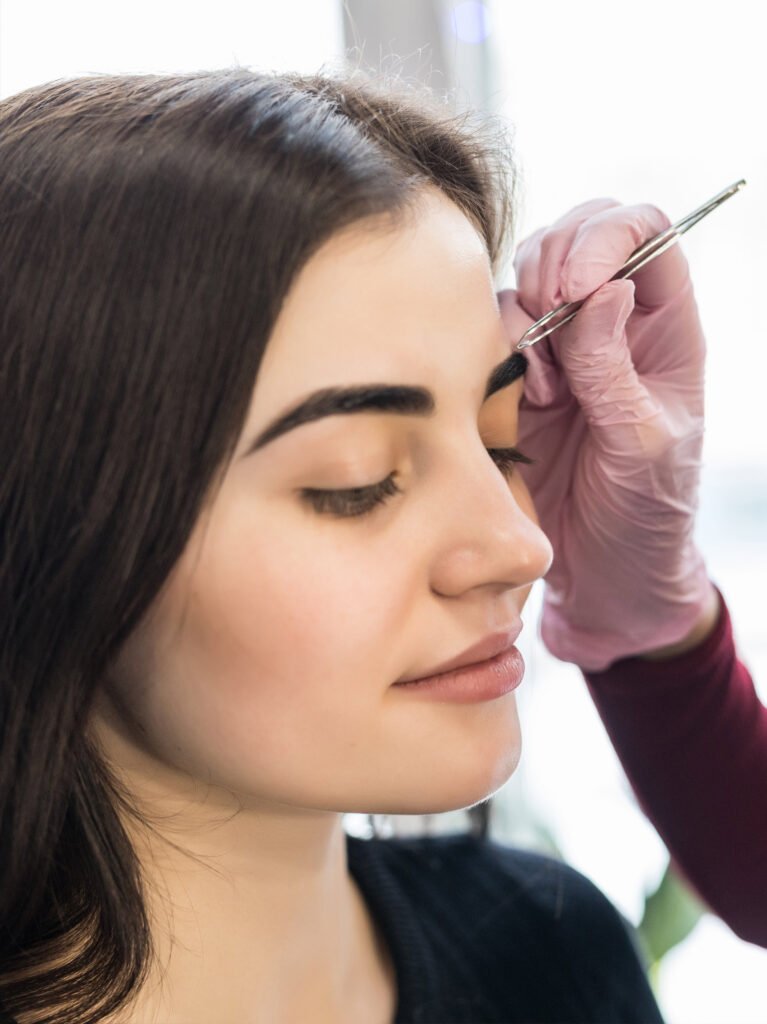 Beauty expert providing eyebrow shaping and eye grooming services at home in Dehradun