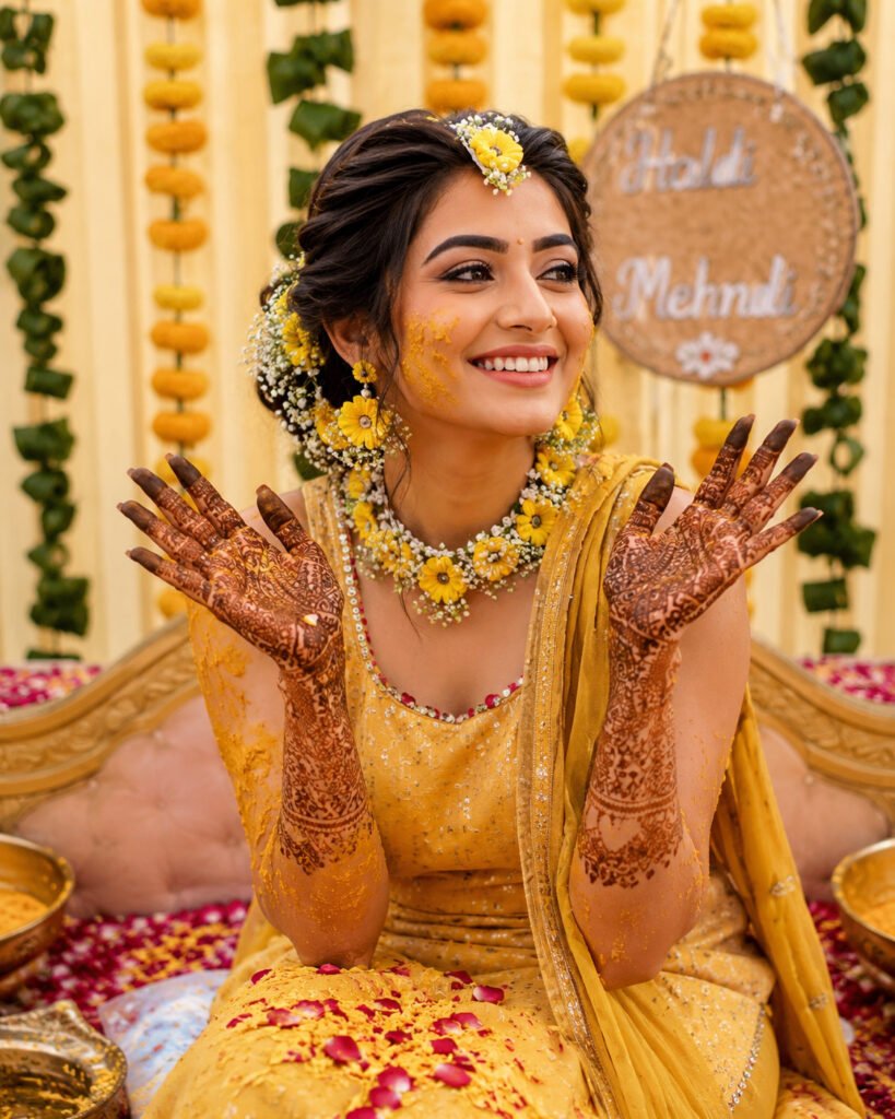 Bride wearing floral jewellery with natural Haldi Mehndi makeup and hairstyle by Aesthetics Salon at Home in Dehradun